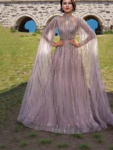 Elegant mauve sequined mesh evening gown featuring dramatic long cape sleeves for women