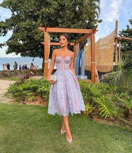 Elegant lavender lace strapless midi dress with delicate floral embroidery in outdoor garden