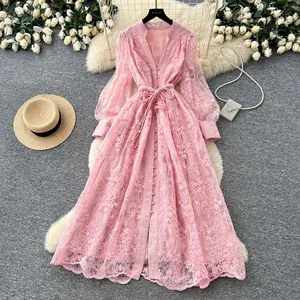 Vue détaillée de la robe en dentelle française rose avec broderie et manches lanterne.