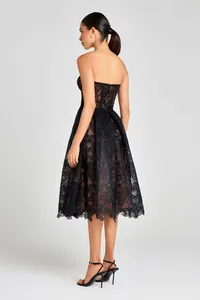 Detailed back view of a black floral lace strapless dress with a flowing A-line skirt