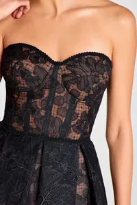 Close-up detail of a elegant black floral lace strapless corset style dress