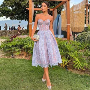 Elegant purple lace strapless evening dress modeled in a lush tropical garden setting