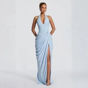 Elegant light blue halter neck evening gown with pleated waist and high slit detail.