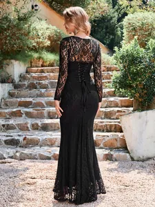 Back view of elegant black lace two-piece dress set with sheer long-sleeve shrug.