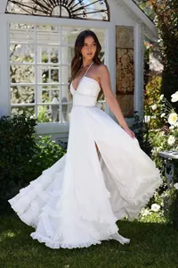 Elegant white tiered ruffle dress with high slit and pearl beaded bodice detailing