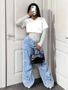 Stylish white lace bodysuit layered under a knitted crop top for a modern look.