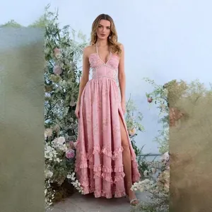 Elegant pink floral halter maxi dress with ruffled hem and high slit for summer vacation