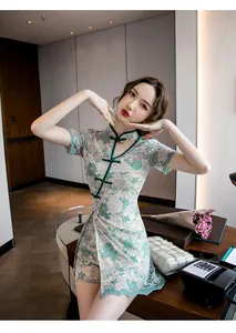 Detailed shot of a modern lace qipao set with elegant teal floral embroidery and hollow-out style