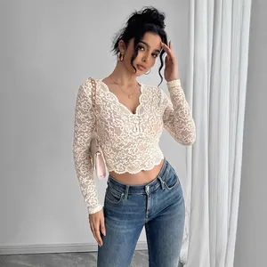 Detailed view of women's off-white floral lace long-sleeve crop top with V-neckline