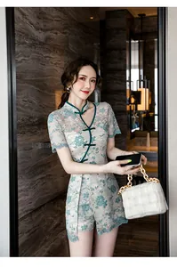 Modernized teal lace Qipao two-piece set styled on a model in a luxurious indoor setting