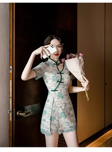 Elegant model wearing a green lace modern cheongsam set in a stylish room setting.