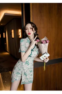 Detailed shot of a modern lace Qipao two-piece set featuring elegant green floral embroidery