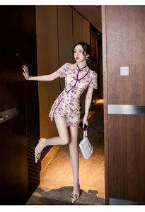 Full body view of a model in a modern purple lace cheongsam set in a luxury hotel hallway
