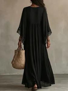 Detailed back view of a black lace maxi dress with elegant batwing sleeves for holiday