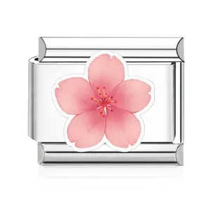 Detailed view of polished stainless steel Italian charm link featuring a pink cherry blossom