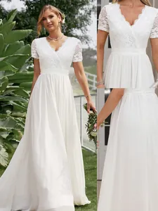 Close-up of white lace bodice and chiffon skirt details on a V-neck wedding gown.