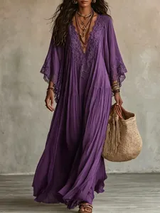 Detailed view of bohemian purple maxi dress with intricate lace V-neck and batwing sleeves