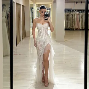 Detailed view of the intricate lace and bone structure of this white strapless evening gown