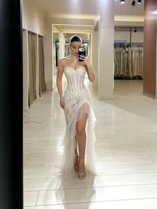 Elegant white strapless lace mermaid evening gown with high slit and corset bodice