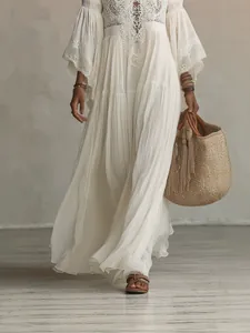 Bohemian white lace maxi dress with V-neck and batwing sleeves for a beach holiday