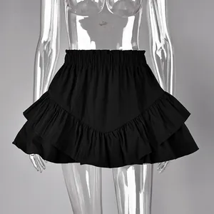 Close-up detail of a black high-waisted tiered ruffle skirt on a transparent mannequin
