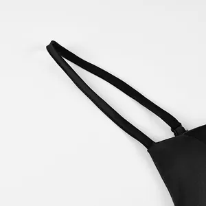 Close-up detail showing the adjustable spaghetti strap of a black A-line cami tank top