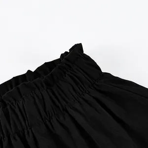 Detailed close-up showing the elastic ruffled waistband texture of a high waist black skirt
