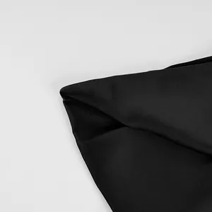Close-up of the smooth black fabric and high-quality stitching on the elegant camisole.