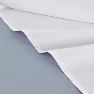 Detailed view of white cotton fabric and neat stitching on long sleeve French shirt