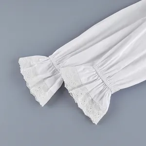 Close-up of white cotton French blouse sleeves with lace embroidered flared cuffs