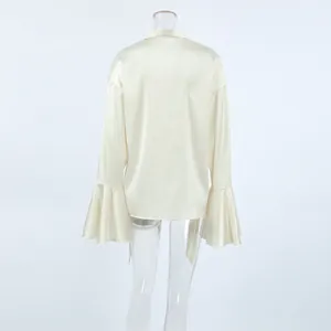 Back view of elegant off-white satin blouse with ruffled bell sleeves and necktie.