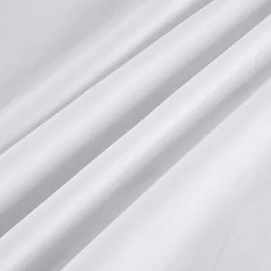 Macro detail of pure white cotton fabric showing high-quality weave texture for shirts