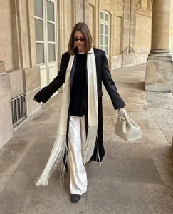 Elegant white satin sash belt with extra long fringe detail on a fashion model.
