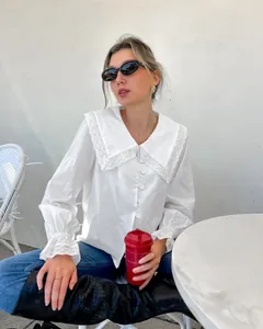 French style white cotton blouse with decorative lace collar and ruffled bell sleeves.