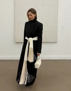 High-end white satin wrap-around waist belt with elegant long fringe tassels on a coat