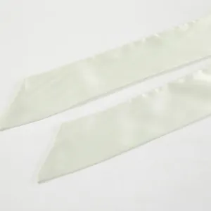Macro view of elegant off-white satin necktie streamers showing soft fabric texture