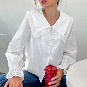 Detailed view of stylish white French cotton shirt featuring a lace collar and flared cuffs