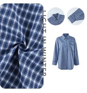 Detail view of women's blue and white checkered plaid cotton shirt with soft texture