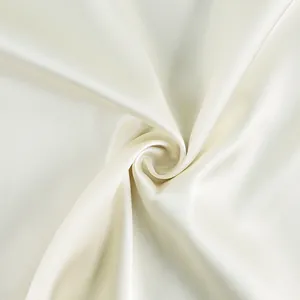 Detailed macro view of elegant ivory satin fabric showing smooth texture and soft luster