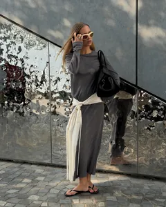 Elegant white satin waist belt with long fringe tassels styling on a grey dress.