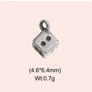 Detailed view of a vintage stainless steel dice pendant including weight and dimensions