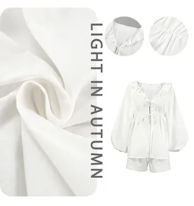 Detailed view of white cotton-linen fabric texture and V-neck ruffle puff sleeve set
