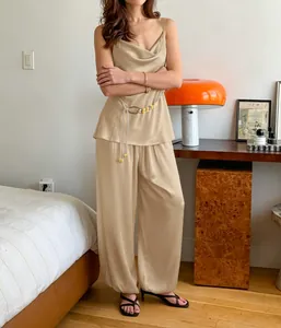 Elegant champagne satin camisole and wide-leg trousers two-piece set shown on a model