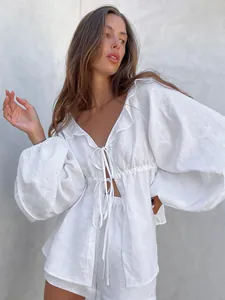 Chic white linen set featuring puff sleeves and a ruffled V-neckline with tie-front details