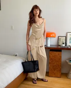 Detailed view of champagne satin camisole and wide-leg trousers set