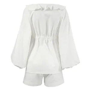 Back view of white cotton linen set with puff sleeves and ruffle collar detail.