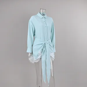 Detailed close-up of light blue French style shirt and lace wrap skirt two-piece outfit
