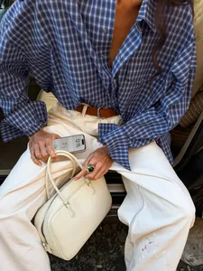 Detailed view of a vintage cotton plaid shirt for women in classic blue and grey