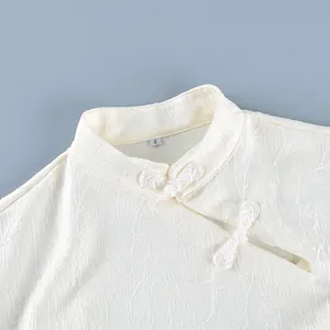 Detail of cream Neo-Chinese blouse featuring stand-up collar and traditional frogs