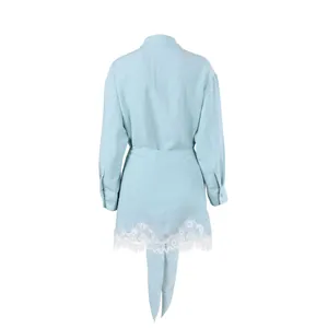 Detail view from the back of a light blue French-style wrap shirt and lace trim skirt set